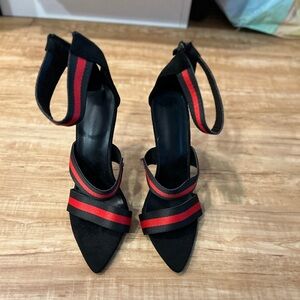 Black and red pointed toe heeled sandals for women.